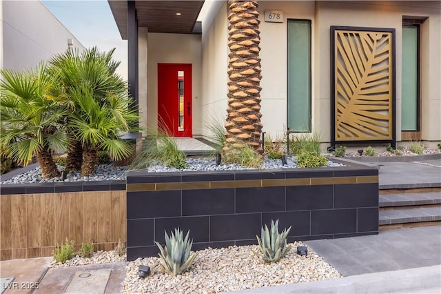 property entrance featuring stucco siding and a tiled roof