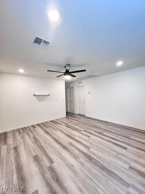 spare room with ceiling fan and light wood-type flooring