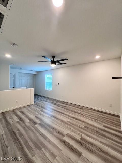 unfurnished living room with ceiling fan and wood-type flooring