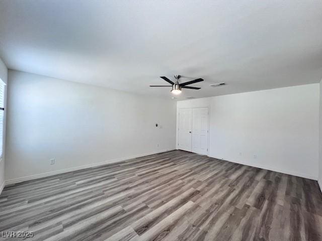 empty room featuring hardwood / wood-style floors and ceiling fan