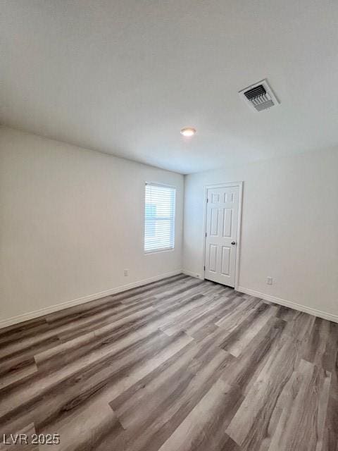 spare room with hardwood / wood-style flooring