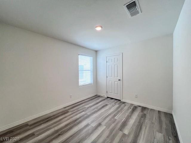 unfurnished room featuring light hardwood / wood-style floors