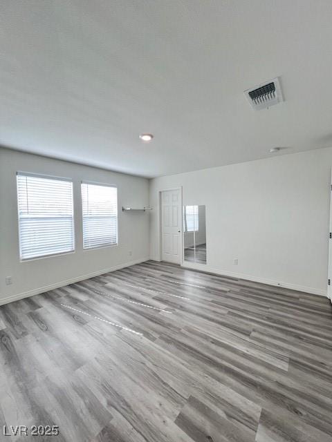 spare room with hardwood / wood-style flooring