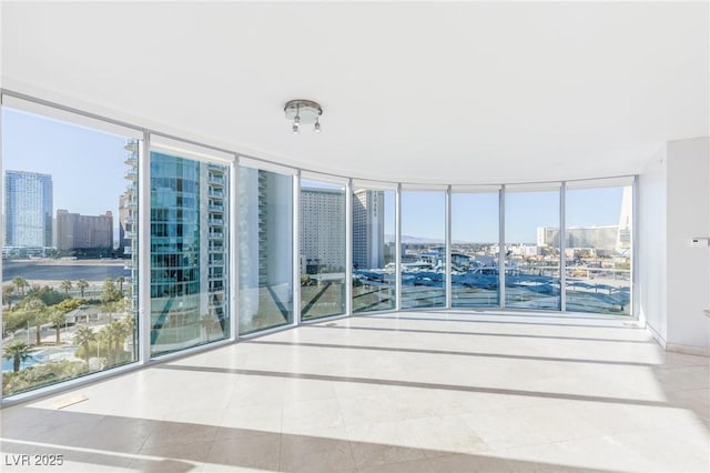 unfurnished sunroom with a water view