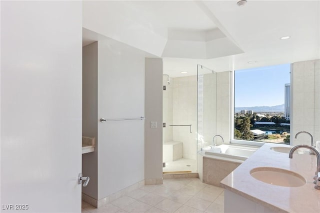 bathroom with separate shower and tub, a mountain view, vanity, and tile patterned floors