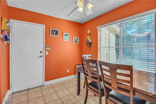 tiled dining space with ceiling fan