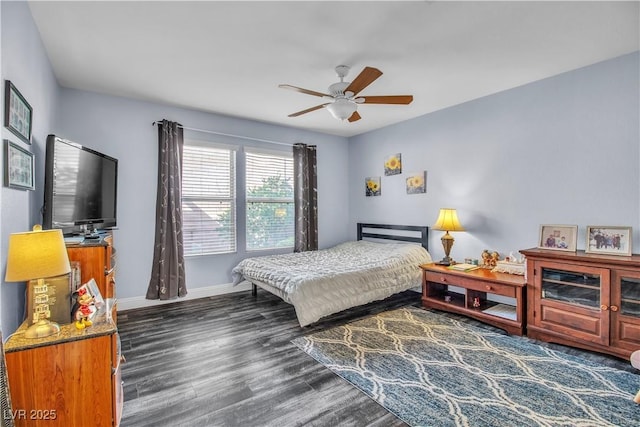 bedroom with ceiling fan and dark hardwood / wood-style floors