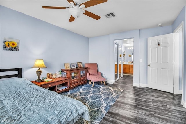 bedroom featuring dark hardwood / wood-style flooring, ceiling fan, and ensuite bath