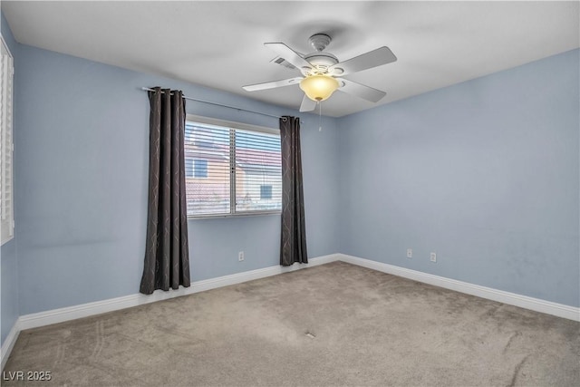 empty room with ceiling fan and light carpet