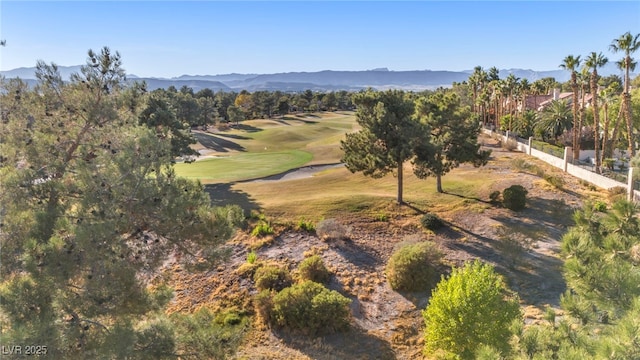 aerial view with view of golf course and a mountain view