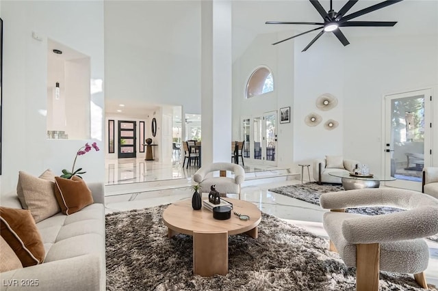 4961 Tierra Del Sol Dr, Las Vegas, NV 89113 - living area with marble tiled floors, high vaulted ceiling, ceiling fan, and plenty of natural light