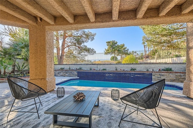 pool featuring a fenced backyard and a patio