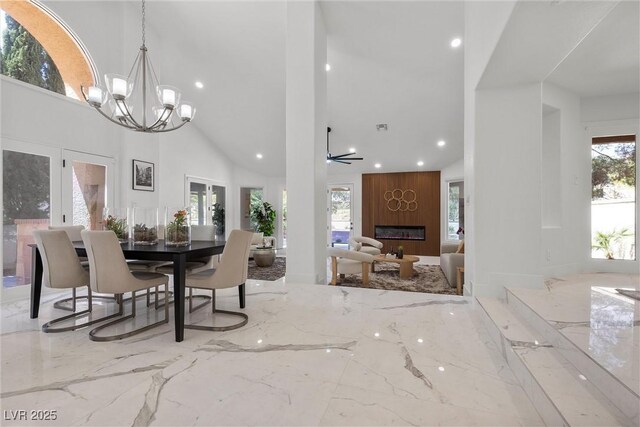 4961 Tierra Del Sol Dr, Las Vegas, NV 89113 - dining space with marble tiled flooring, a high ceiling, recessed lighting, a fireplace, and a chandelier