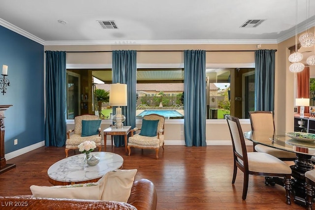 living area featuring dark wood-style flooring, visible vents, and crown molding