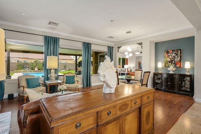 interior space with crown molding, visible vents, brown cabinetry, and dark wood-type flooring