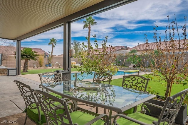 view of patio with a fenced backyard, a fenced in pool, and outdoor dining space