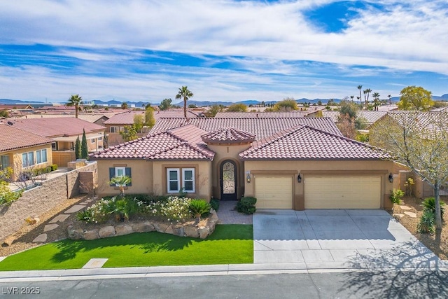 mediterranean / spanish house with driveway, a tile roof, a residential view, an attached garage, and stucco siding