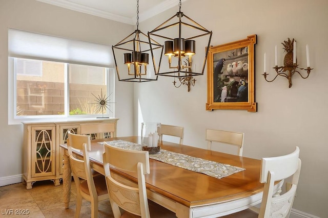 dining area featuring a notable chandelier, crown molding, and baseboards