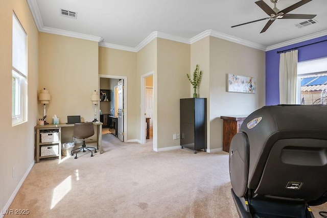 home office featuring light carpet, a ceiling fan, visible vents, and crown molding