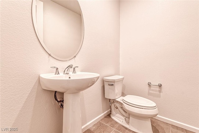 bathroom featuring sink, tile patterned flooring, and toilet