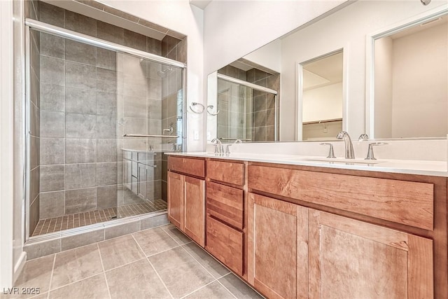 bathroom featuring vanity, tile patterned flooring, and a shower with door