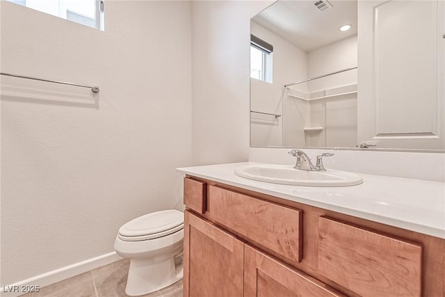 bathroom with tile patterned flooring, vanity, toilet, and a shower