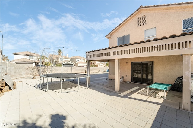 view of patio with a fenced backyard and a trampoline