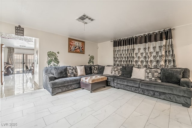 living area with marble finish floor and visible vents