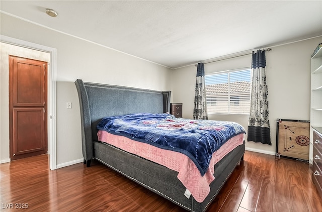 bedroom with dark wood-style floors and baseboards