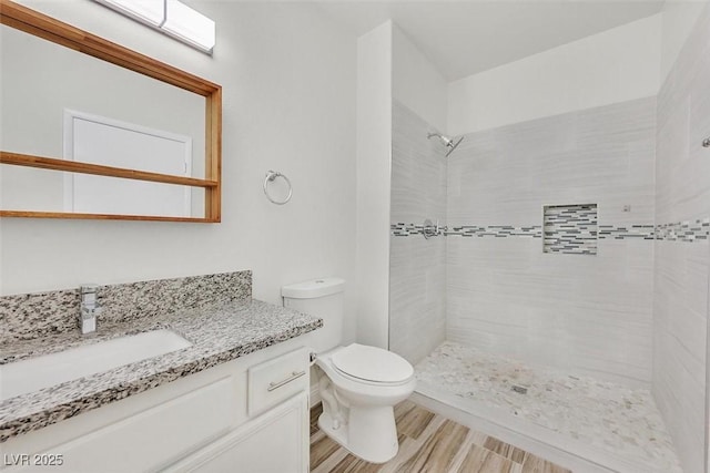 9050 W Warm Springs Rd Unit 2153, Las Vegas, NV 89148 - full bath with vanity, a tile shower, toilet, and wood finished floors