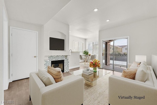 9050 W Warm Springs Rd Unit 2153, Las Vegas, NV 89148 - living area with wood finished floors, recessed lighting, a tiled fireplace, and baseboards