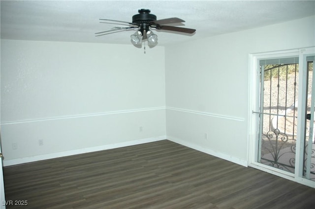 unfurnished room with ceiling fan and dark wood-type flooring