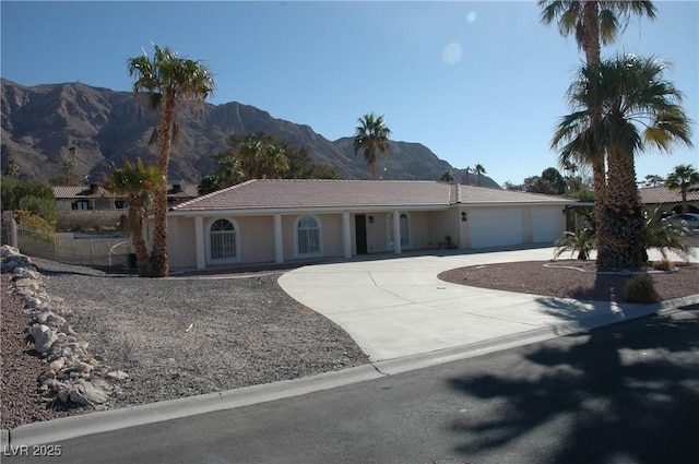 ranch-style house with a mountain view and a garage