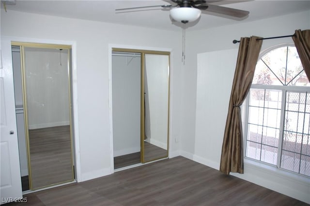 unfurnished bedroom with ceiling fan, a closet, and dark hardwood / wood-style flooring