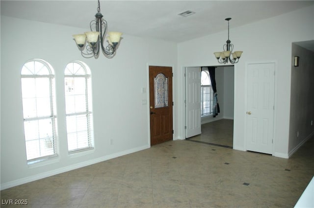 interior space featuring a chandelier, plenty of natural light, and lofted ceiling