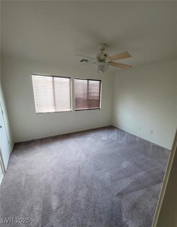 empty room with ceiling fan and carpet floors