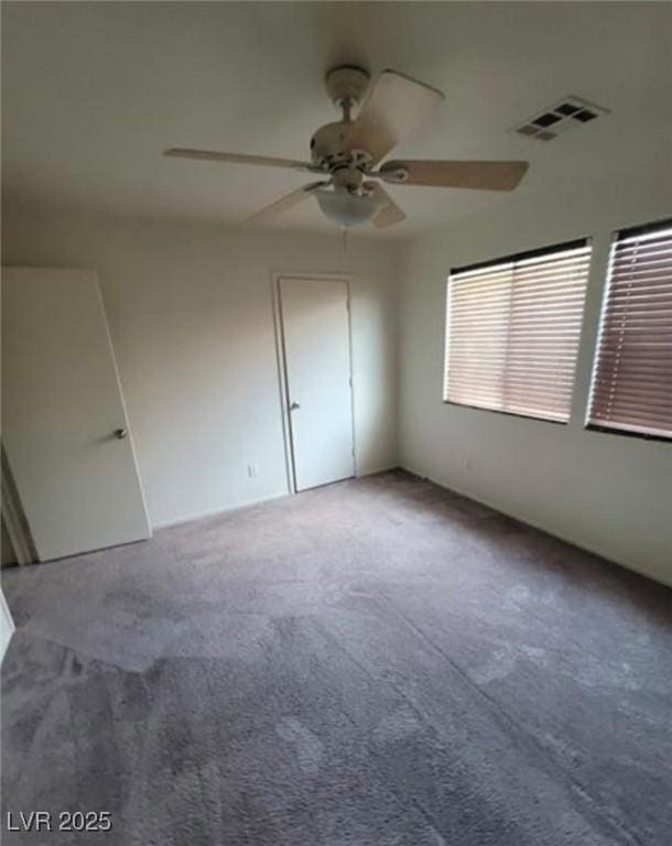 carpeted empty room with ceiling fan