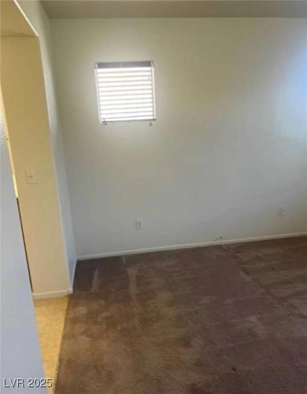 unfurnished room with dark carpet