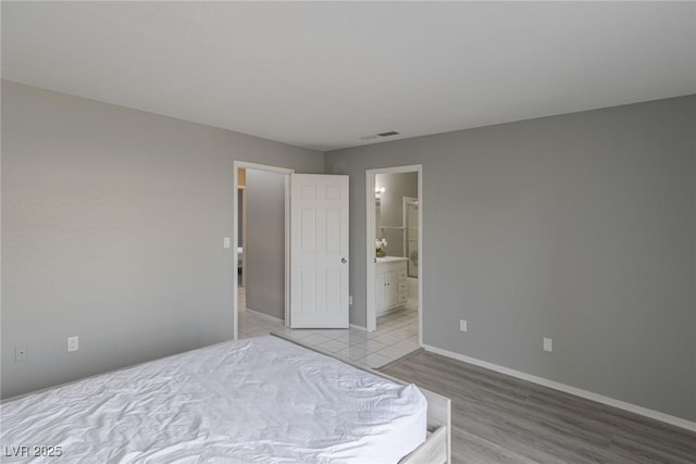 6250 W Flamingo Rd Unit 7, Las Vegas, NV 89103 - unfurnished bedroom with light hardwood / wood-style floors and ensuite bath