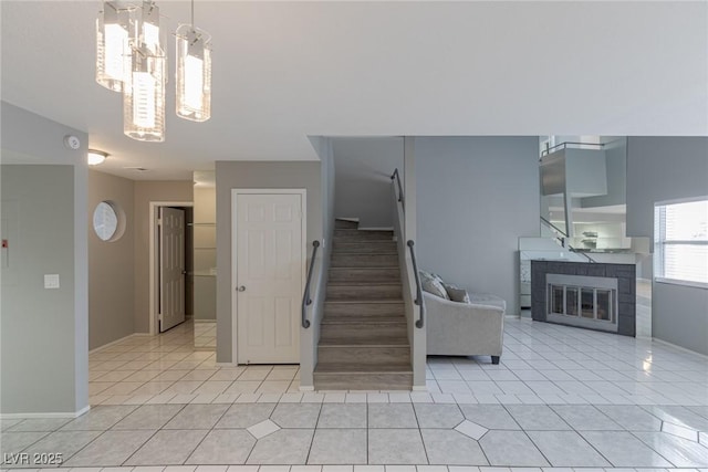 6250 W Flamingo Rd Unit 7, Las Vegas, NV 89103 - stairway featuring a fireplace, a notable chandelier, and tile patterned floors