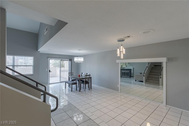 6250 W Flamingo Rd Unit 7, Las Vegas, NV 89103 - unfurnished dining area with light tile patterned flooring and an inviting chandelier