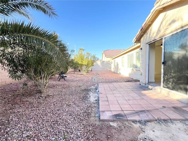 view of yard featuring a patio and fence