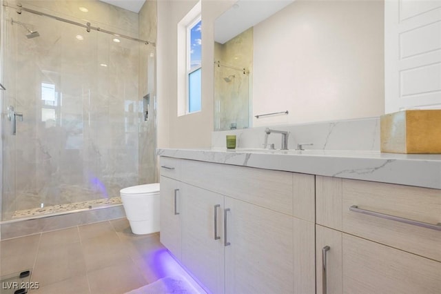 bathroom with toilet, a stall shower, tile patterned floors, and vanity