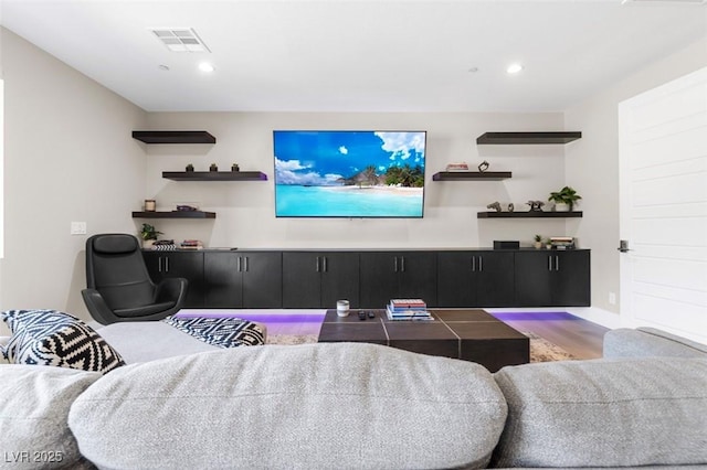 living room featuring recessed lighting, visible vents, and wood finished floors