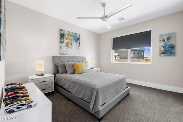 bedroom with ceiling fan, dark colored carpet, and baseboards