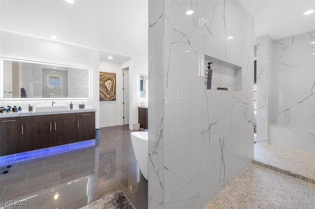 bathroom with a marble finish shower, marble finish floor, a freestanding bath, vanity, and recessed lighting