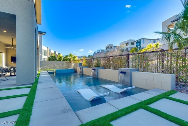 exterior space featuring a fenced backyard, a residential view, ceiling fan, and a fenced in pool