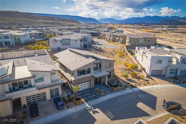 drone / aerial view featuring a residential view and a mountain view