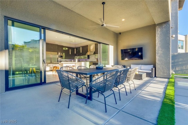 view of patio featuring an outdoor living space, a ceiling fan, and outdoor dining space