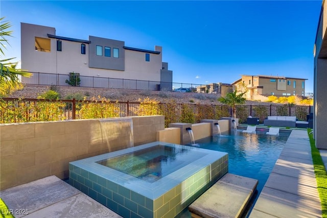 view of swimming pool with fence and an in ground hot tub